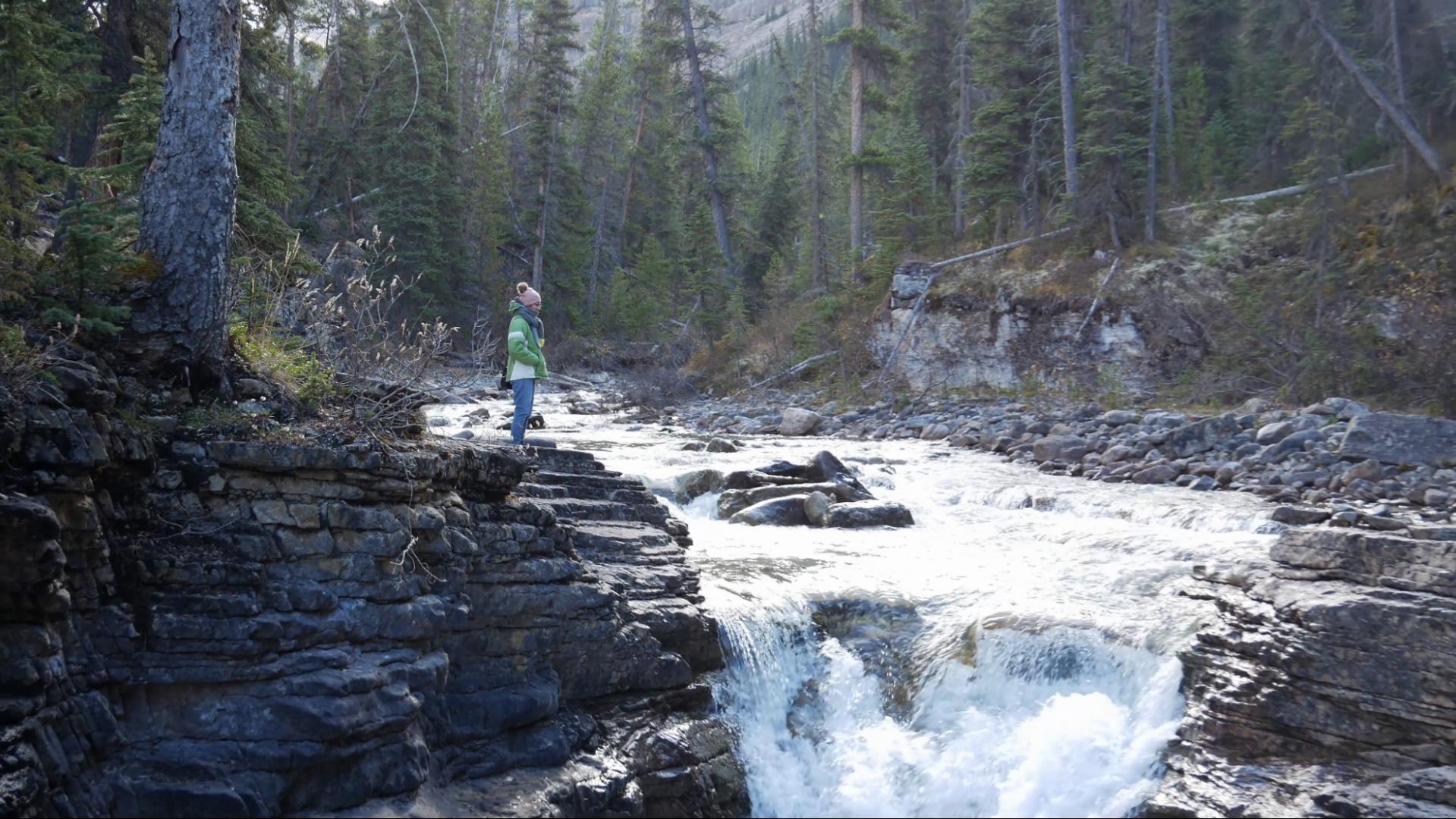 Mel stands at the top of Stanley Falls on the Icefields Parkway between Jasper and Banff National Parks in Alberta, Canada. 