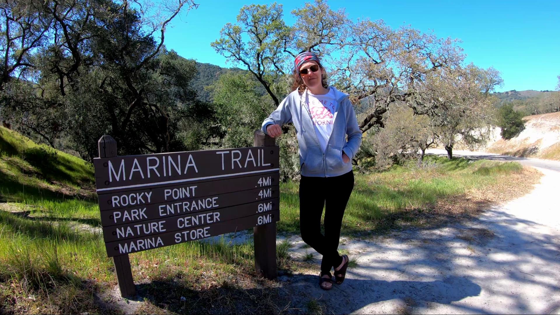 Walking Trails at Lopez Lake Mel standing next to one of the hiking trail signs at Lopez Lake.