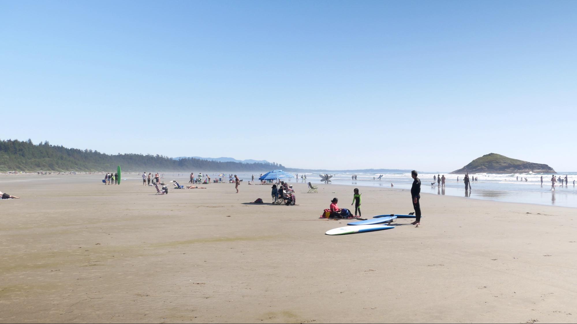 Long Beach, Tofino Long beach on a sunny day in Tofino. Lots of people enjoying the water, waves, and sun.